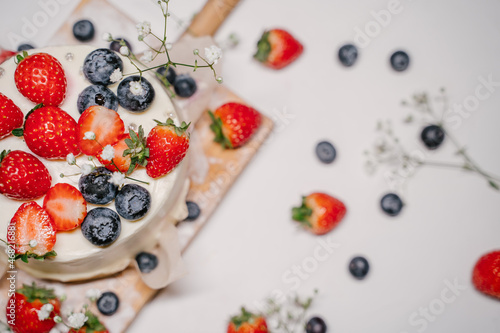 Beautiful strawberry cake decorated with strawberries and blueberries