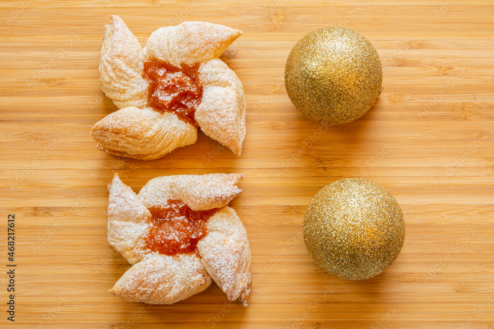 Joulutorttu, traditional finnish christmas pastry with marmalade on the wooden board and christmas balls