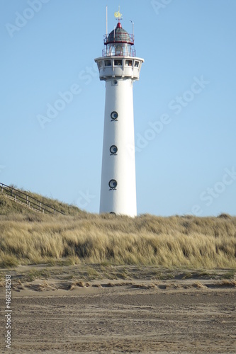 J. C. J. van Speijk Lighthouse seen from the beach on a cold and sunny winter day, Egmond aan Zee, North Holland, Netherlands  © Jens