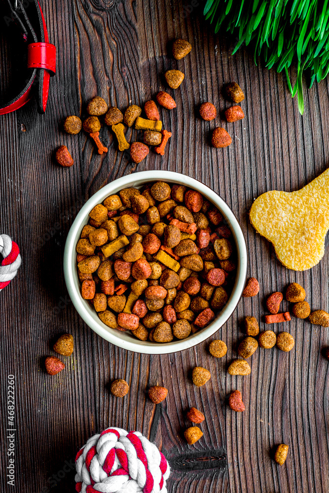 dry dog food in bowl on wooden background top view dry dog food in bowl on wooden background top view