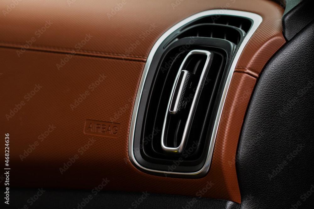 Car air conditioning close up view. The air conditioner flow inside the car. Detail interior of car. Air ducts. Car air conditioning close up view. The air conditioner flow inside the car. Detail interior of car. Air ducts.