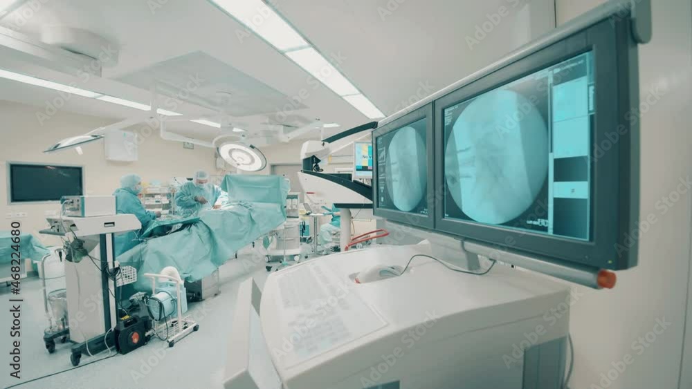 Operating room with a group of surgeons and scan images Operating room with a group of surgeons and scan images