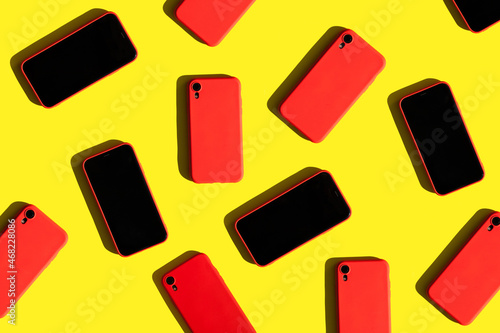 Photography many red cell phones on yellow background