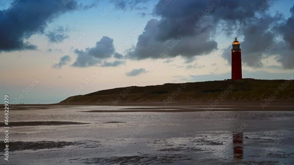 Lighthouse at the Wadden island Texel in the dunes during sunset after a stormy autumn day. The Eierland lighthouse is located at the North point of the island. Lighthouse at the Wadden island Texel in the dunes during sunset after a stormy autumn day. The Eierland lighthouse is located at the North point of the island.