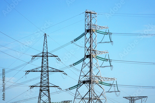 Power line towers against the blue sky.