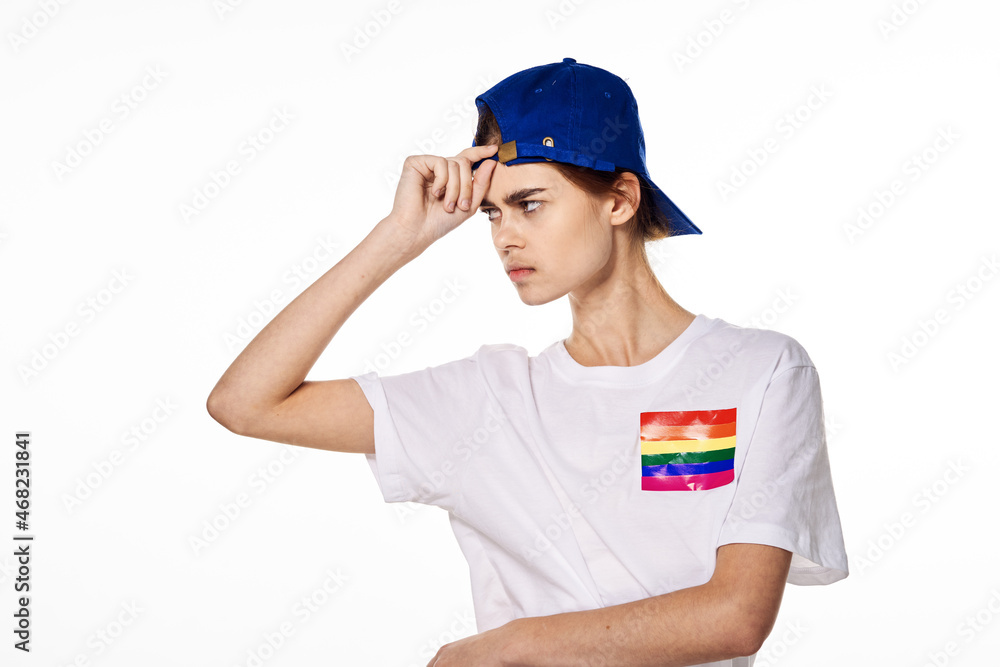 girl in white t-shirt lgbt flag transgender posing light background