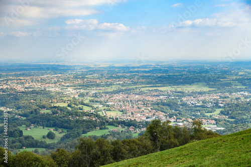 Panoramic view of the Po Valley in the province of Biella and Vercelli. Natural and city panorama on a sunny summer day in northern Italy. City, crops and rice fields in the background. Landscape.