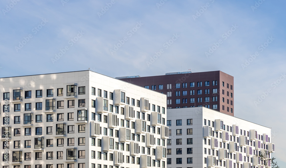 Modern residential complex with balconies. Towers and skyscrapers in flat design. Copy space