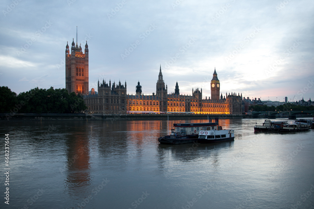 River Thames boats and Parliament at dusk
