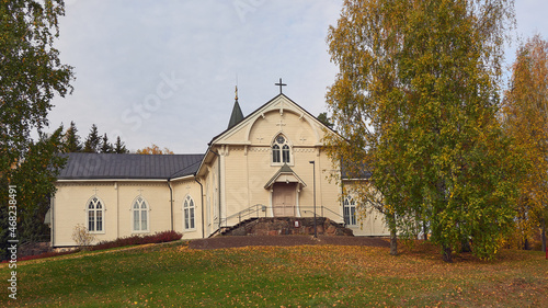 Lutheran Church in the Finnish town of Askola: autumn, colorful trees, sunny day.