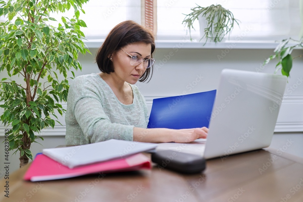 Business woman working at home online using laptop. Business woman working at home online using laptop.
