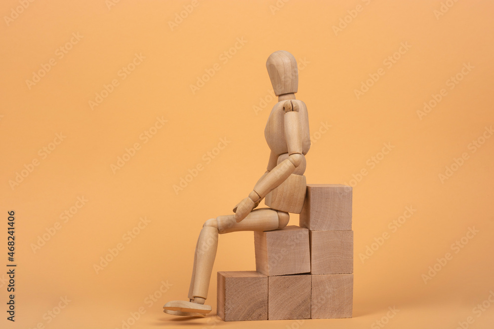 Success concept. Wooden mannequin on a ladder made of wooden blocks. Success concept. Wooden mannequin on a ladder made of wooden blocks.