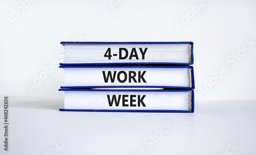 4-day work week symbol. Concept words '4-day work week' on books. Beautiful white background. Copy space. Business and 4-day work week concept. photo