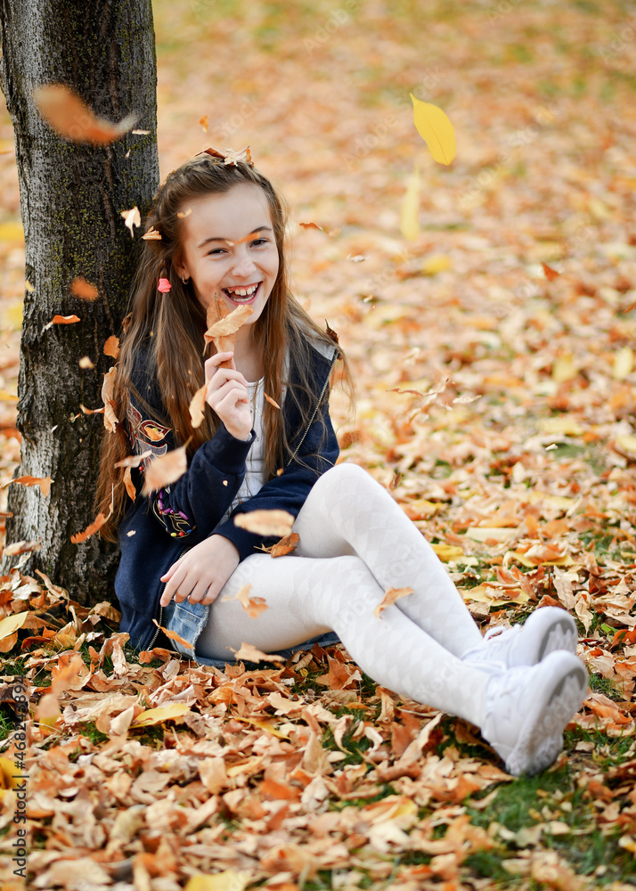 Cute girl playing with foliage. Autumn. Happiness. Atmosphere. Cute girl playing with foliage. Autumn. Happiness. Atmosphere.