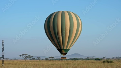 Hot air balloon over landscape of Serengeti National Park, Tanzania, Africa photo