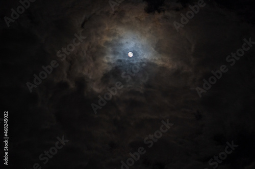 the moon between clouds