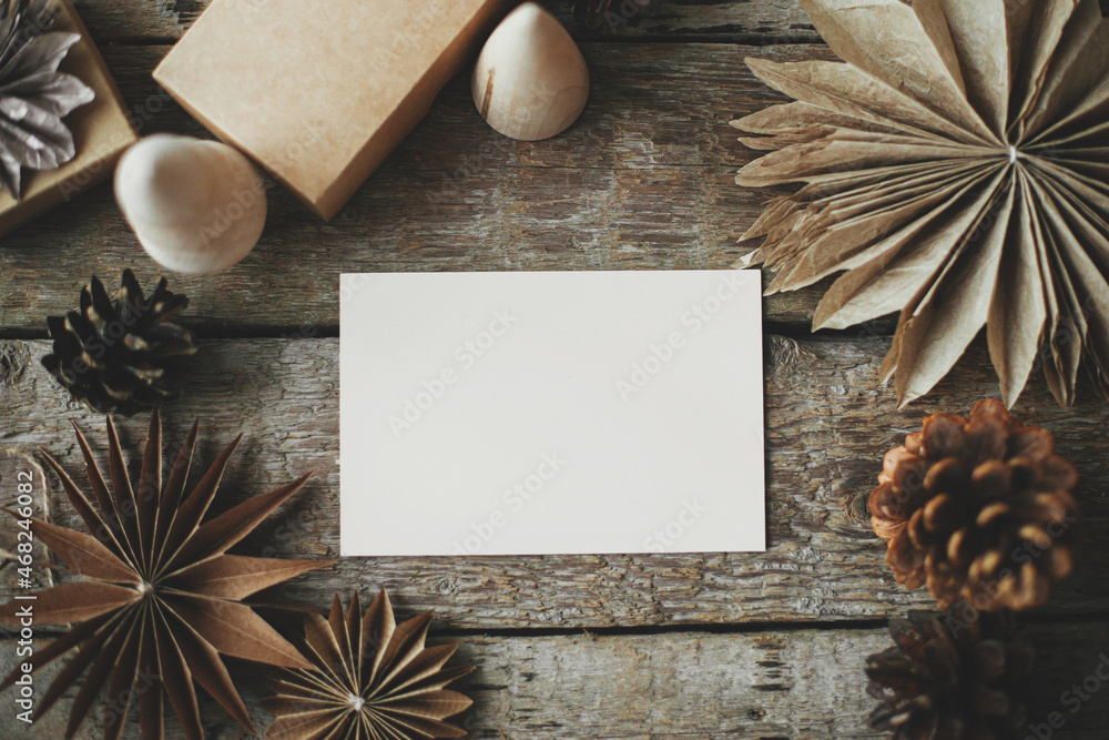 Empty greeting card and christmas paper stars, wooden tree and pine cones on rustic background. Flat lay. Space for text. Christmas card mock up. Seasons greetings template. Plastic free Empty greeting card and christmas paper stars, wooden tree and pine cones on rustic background. Flat lay. Space for text. Christmas card mock up. Seasons greetings template. Plastic free