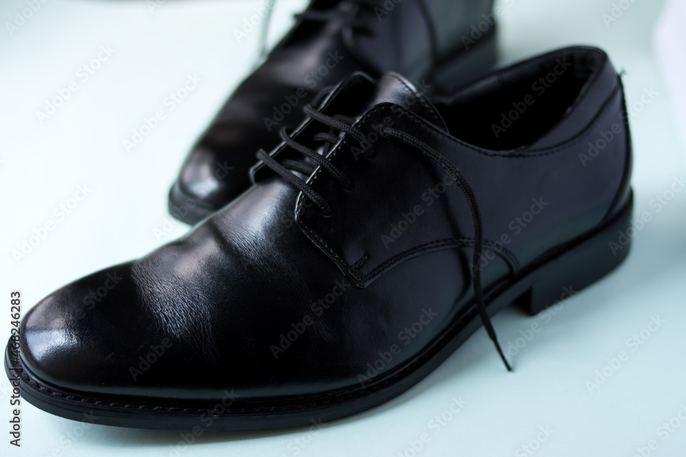 Close up of some fancy black bright shoes on a green surface Close up of some fancy black bright shoes on a green surface