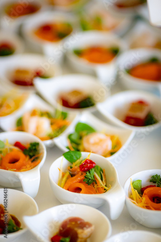 Fototapeta Naklejka Na Ścianę i Meble -  Beautifully decorated catering banquet table with variety vegan vegetarian fish snacks in wedding celebration venue