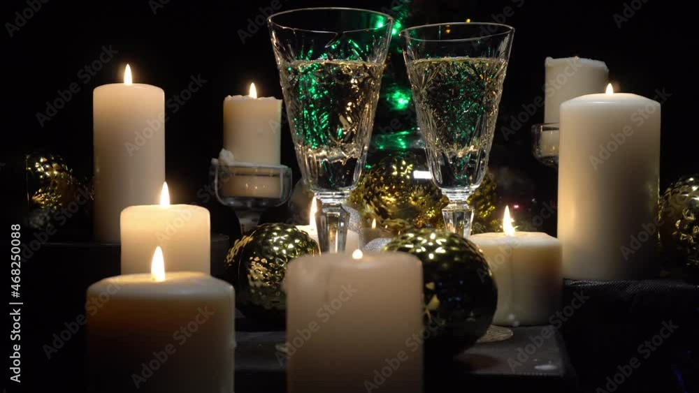 Champagne glasses on the background of burning candles and Christmas and new year decorations, dolly shot Champagne glasses on the background of burning candles and Christmas and new year decorations, dolly shot