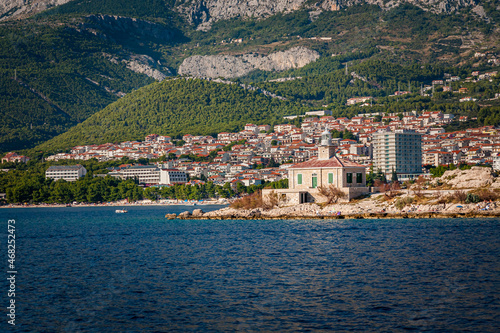 Navigational lighthouse stands in front of the town of Makarska, Croatia