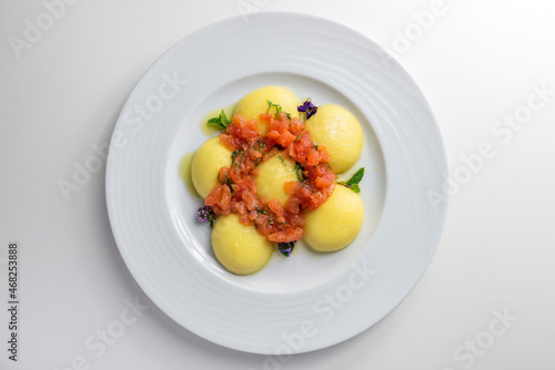 Dish of Potato ravioli stuffed with tomato concassé photo