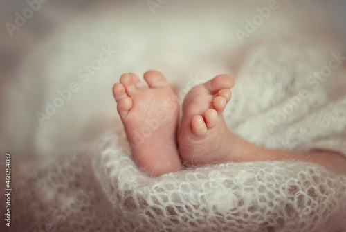 a small child is lying on the bed, tiny cute legs close-up, shallow focus 
