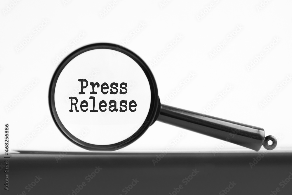 magnifying glass with text press release on notebook magnifying glass with text press release on notebook