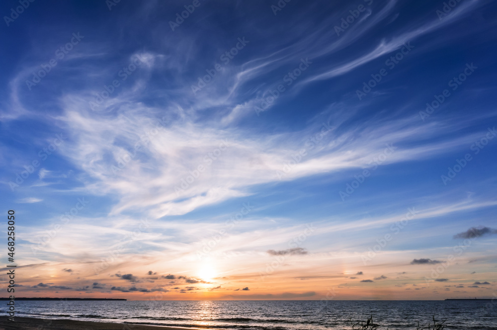 Sunset over the sea. Reflection of sunlight in the sea waves. The sky in the sunset rays. Sunset over the sea. Reflection of sunlight in the sea waves. The sky in the sunset rays.