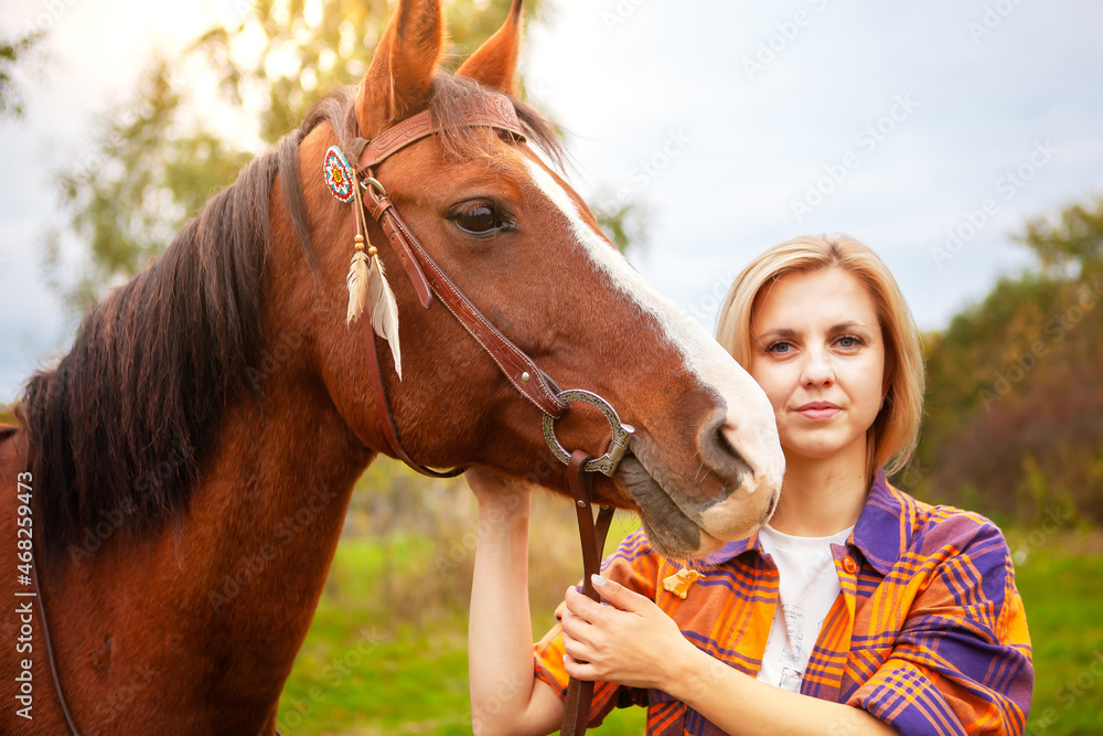 Obraz premium Beautiful young blond woman with a horse, portrait.