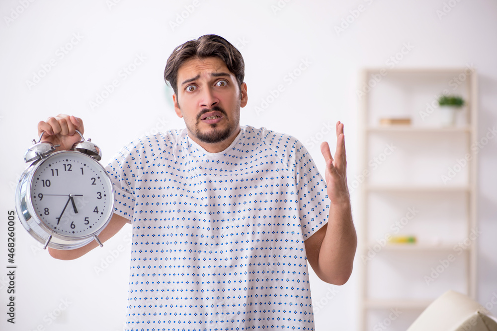 Young male patient in time management concept Young male patient in time management concept