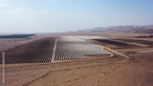 Aerial View of Solar Panel Park or farm Solar panels in the desert among the mountains in Timna, Israel. Drone Aerial Shot Of Power Station Over Landscape On Sunny Day Against Sky at the Negev, Israel photo