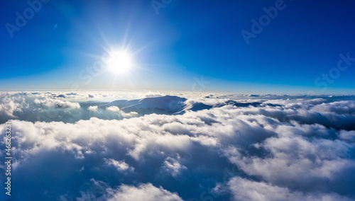 Fototapeta Naklejka Na Ścianę i Meble -  Flight through evening sky with clouds over mountain