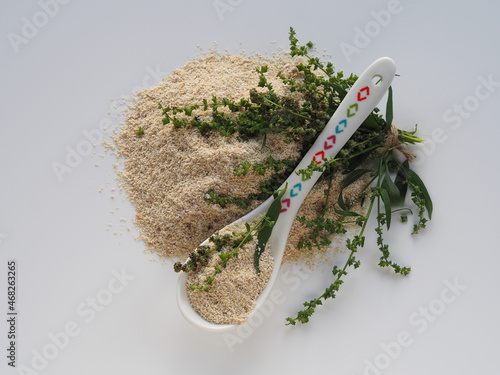 Isolated flour, grits in a spoon, grass garden orach with seeds on a white table, flat layout. Medicinal plant atriplex hortensis for use in dietary and vegetarian nutrition, natural gluten-free food photo