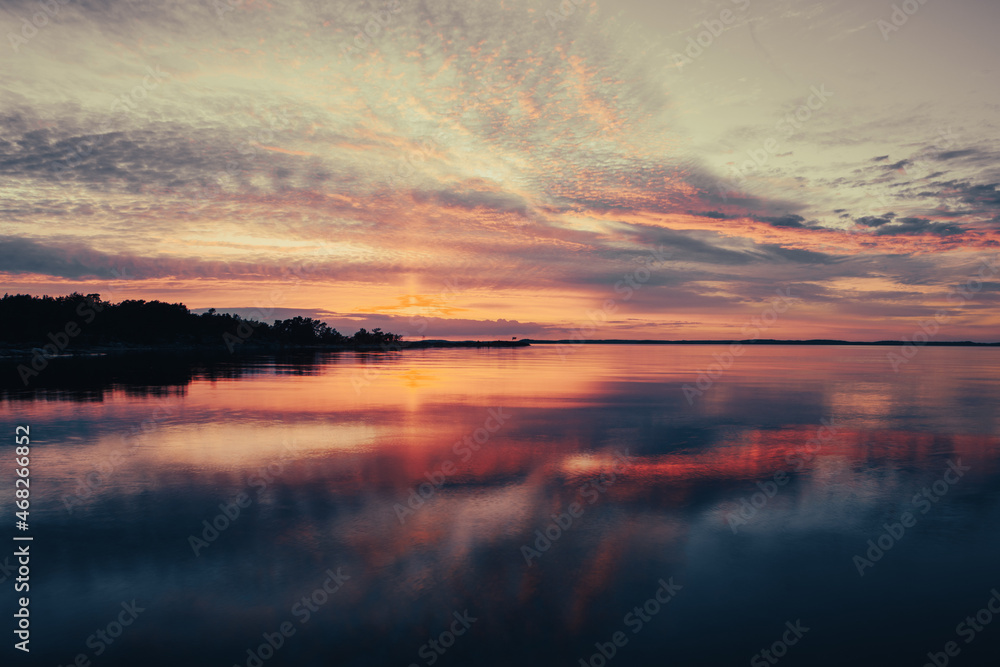 Colorful sunset with clouds over the lake