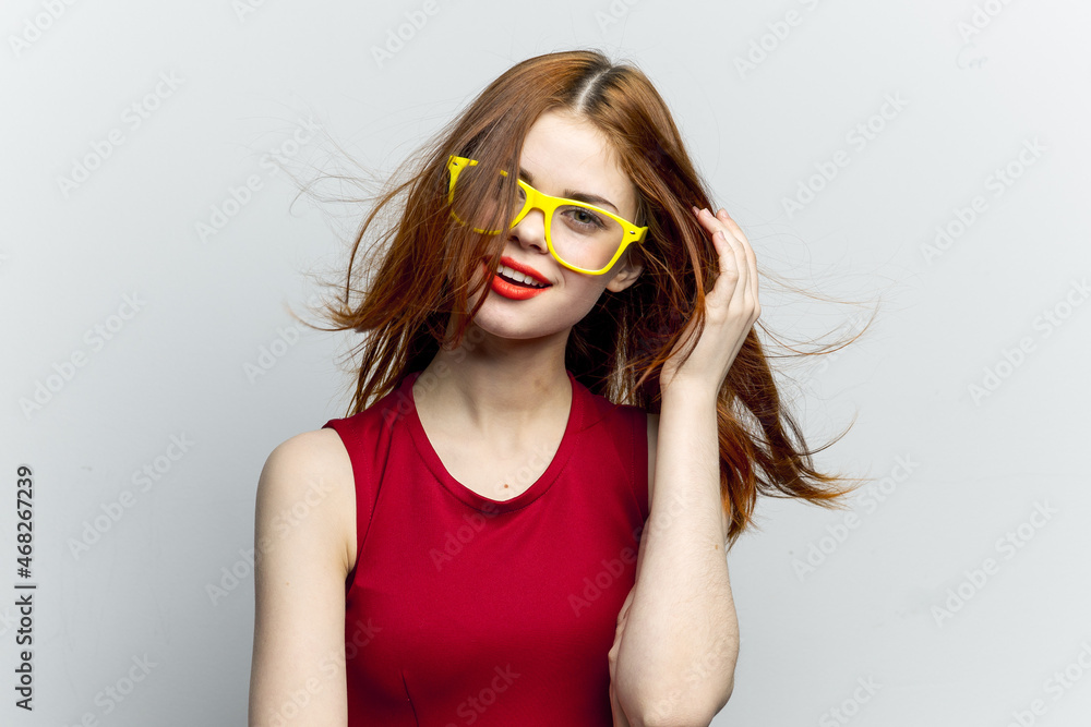 emotional woman in red dress yellow glasses posing emotional woman in red dress yellow glasses posing