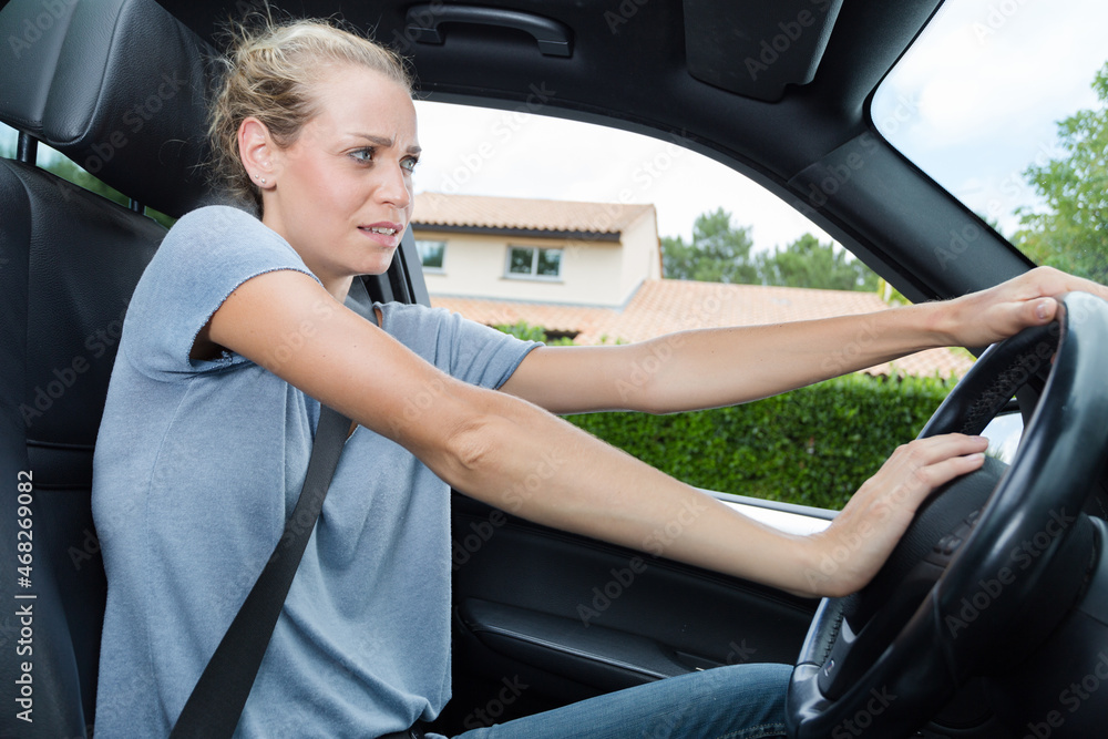 closeup photo of woman driving car and honking