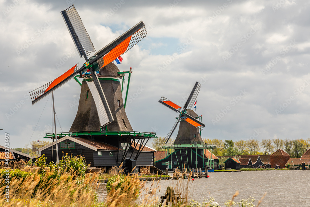 Colorful Dutch Windmills at the river Zaan, Zaanse Schans, Zaandam, The Netherlands