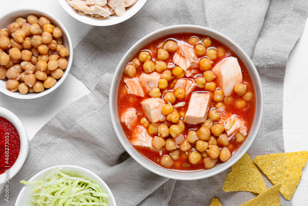 Bowl with delicious pozole soup and ingredients on light6 table Bowl with delicious pozole soup and ingredients on light6 table
