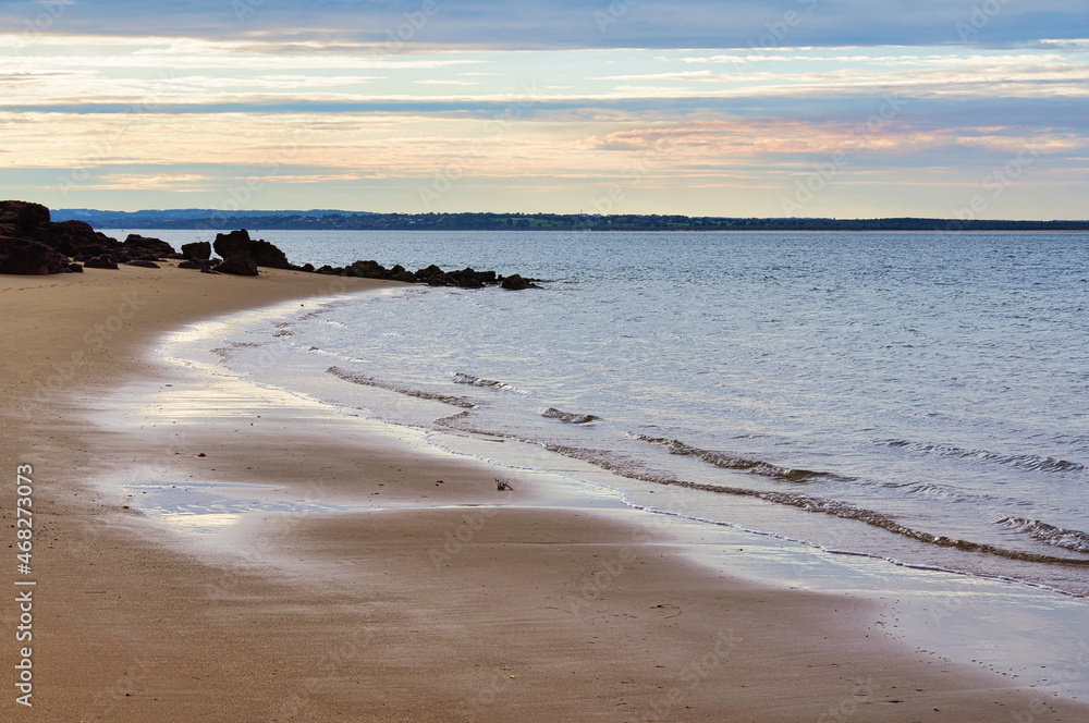 Gentle waves wash Erehwon Point Beach - Cowes, Victoria, Australia