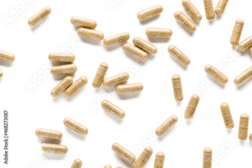 Vitamin K pills scattered on white background photo