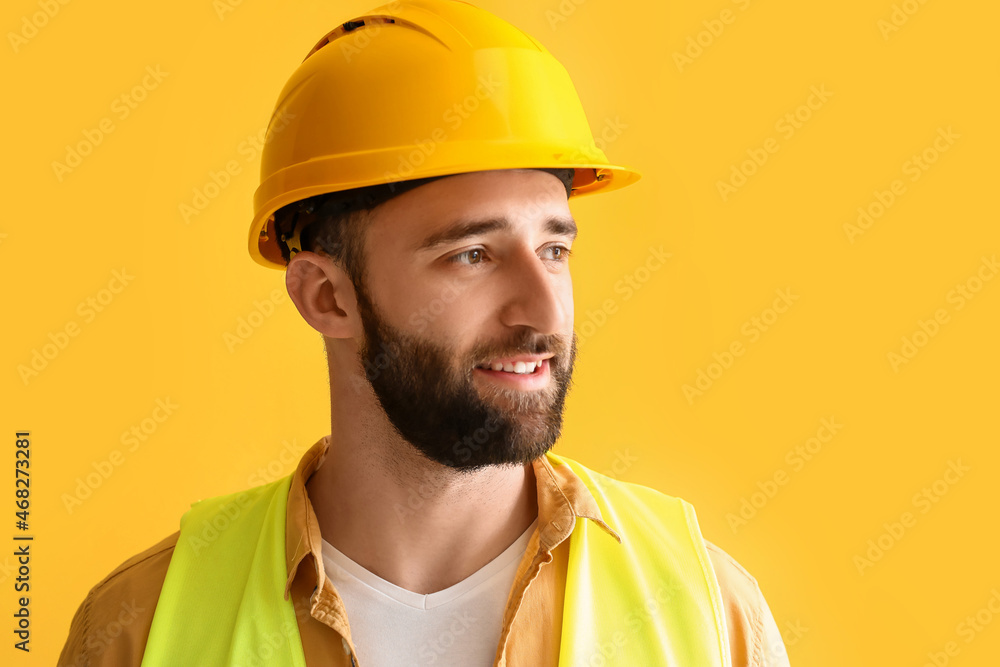 Construction worker in hardhat on yellow background Construction worker in hardhat on yellow background