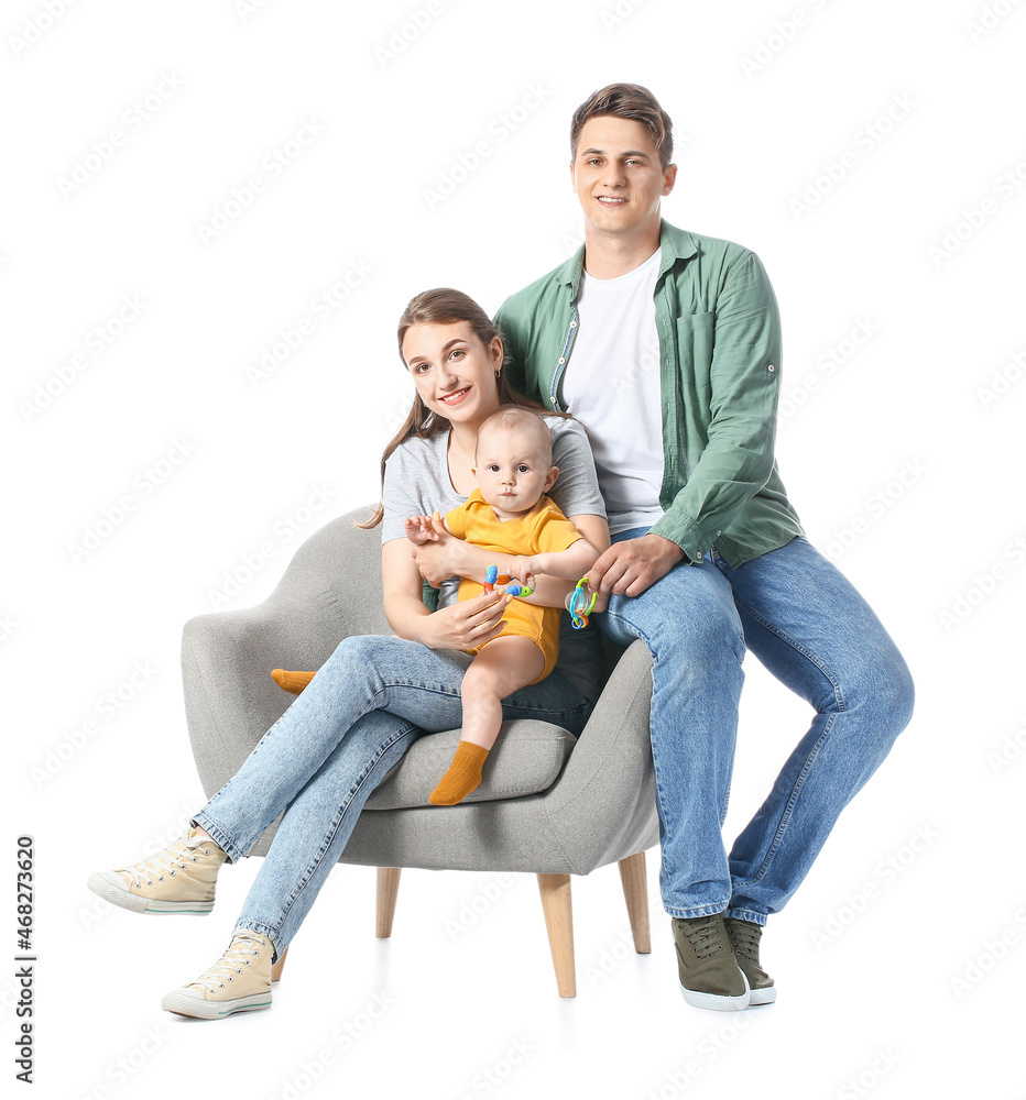 Young parents with little baby and toys sitting in armchair on white background Young parents with little baby and toys sitting in armchair on white background