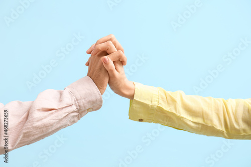 Two people holding hands, s...