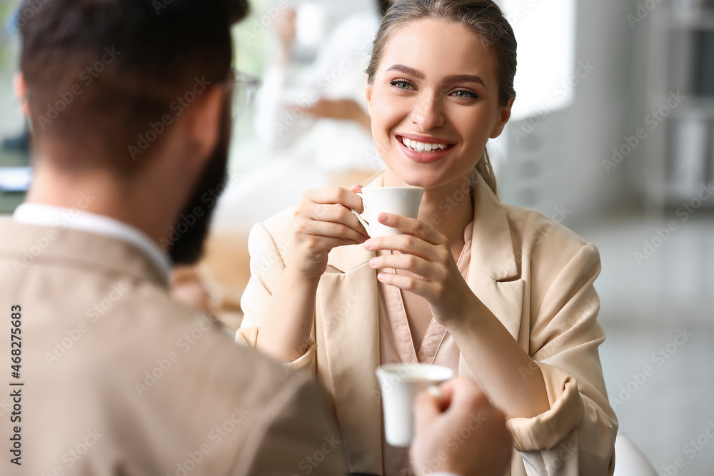 Business people having coffee break in office Business people having coffee break in office