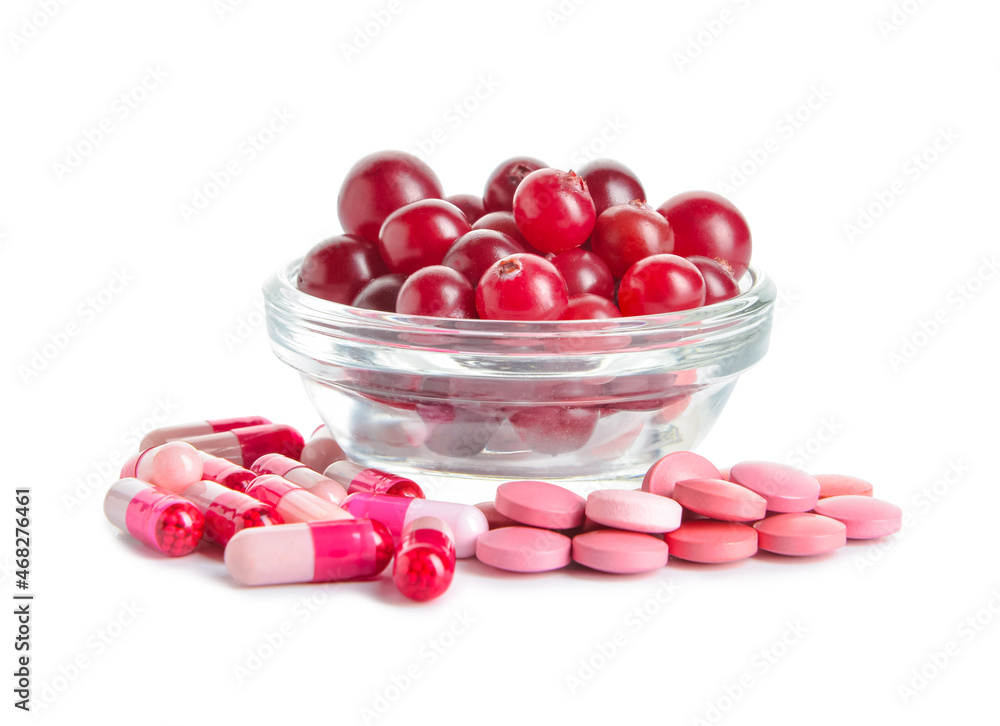 Cranberry pills and bowl of berries on white background Cranberry pills and bowl of berries on white background