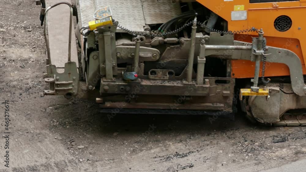 Tracked crawler asphalt paver constructs a new asphalt pavement of the roadway.
Unmodified camera color. Tracked crawler asphalt paver constructs a new asphalt pavement of the roadway.
Unmodified camera color.