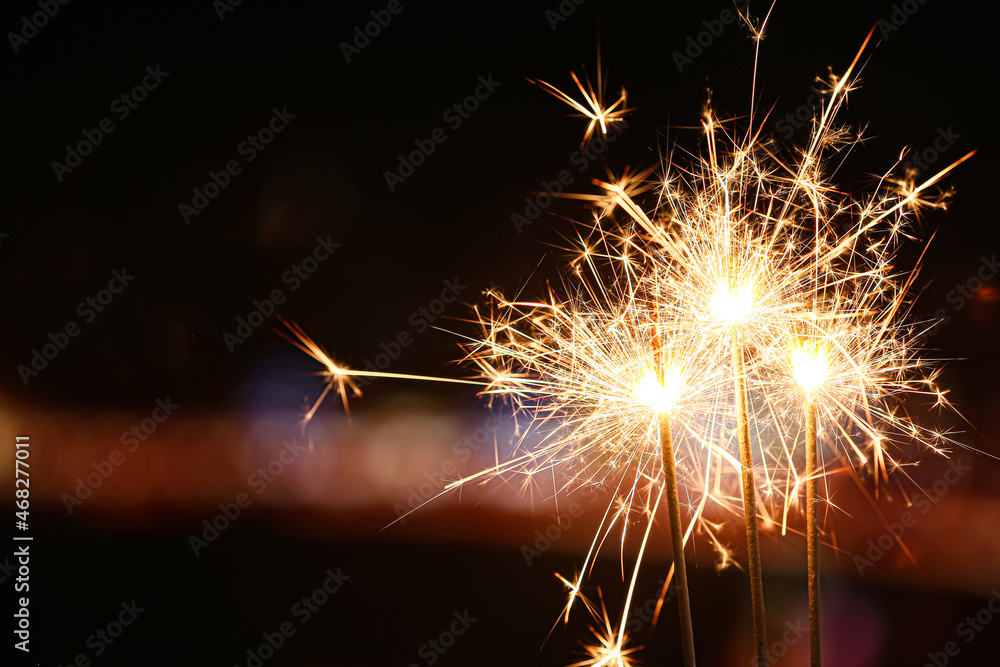 Fototapeta premium Beautiful sparklers at night outdoors