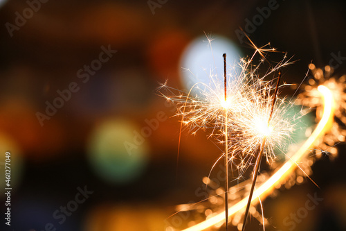 Beautiful burning sparklers at night city  closeup