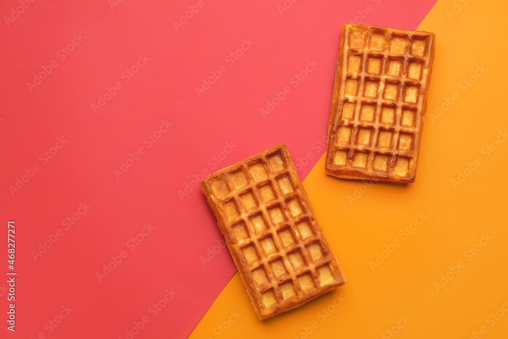 Delicious golden Belgian waffles on color background Delicious golden Belgian waffles on color background